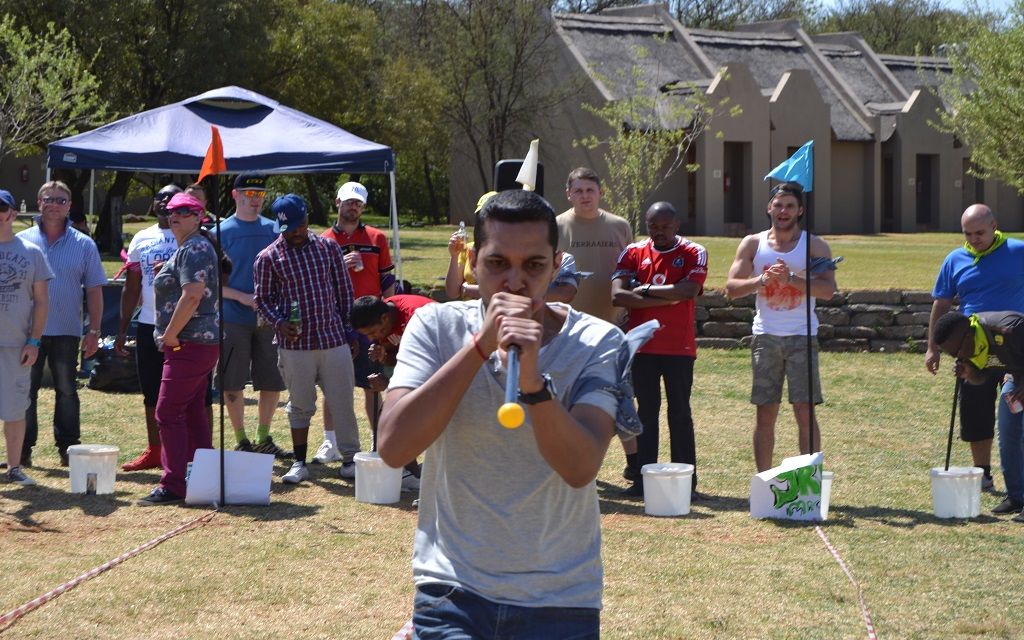 Hybrid team reconnecting in person at an outdoor multi-sports team building day
