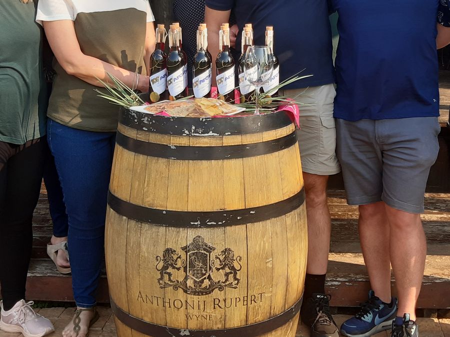 Finished wine blends displayed on a barrel