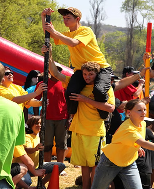 man sitting on another mans shoulders