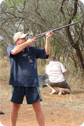 Man Shooting Clay Pigeon in bush