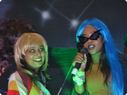 women singing karaoke